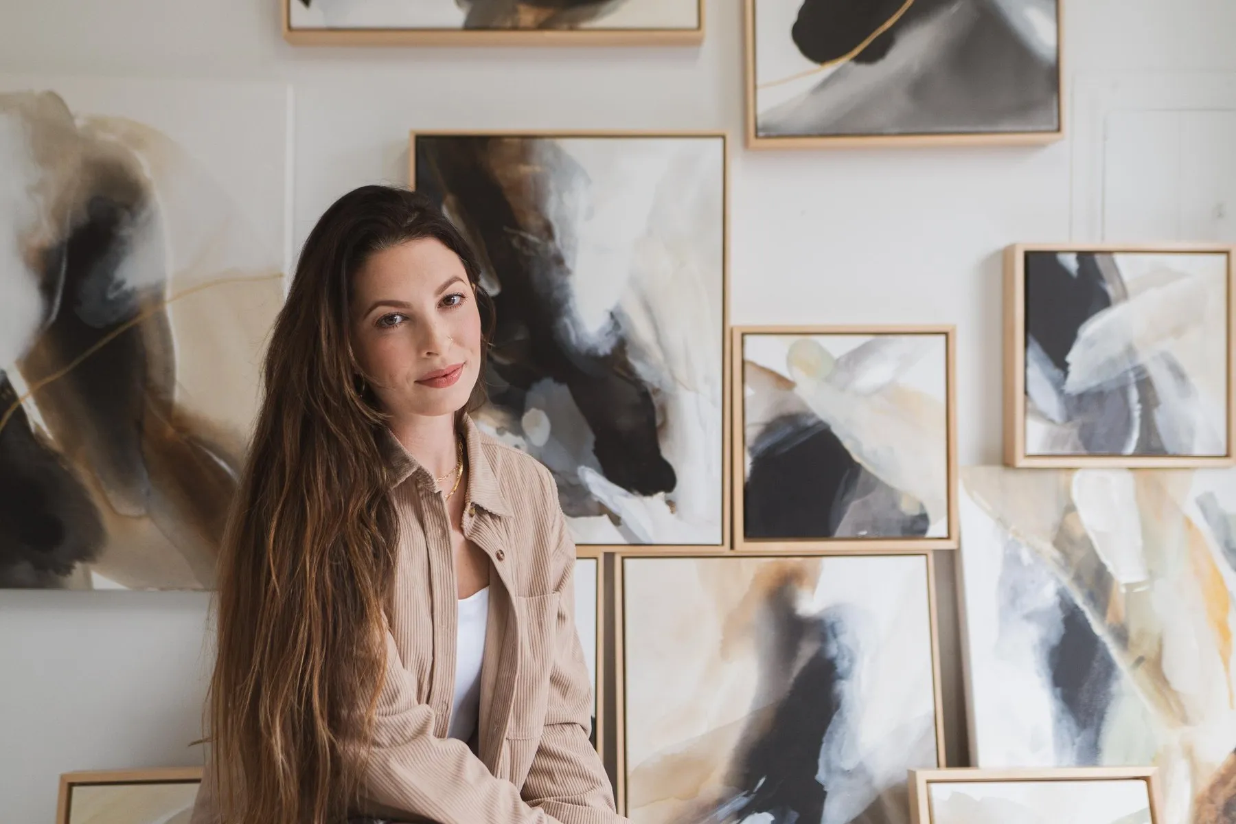 Rachel Reinert with her A Change Within paintings on the studio wall