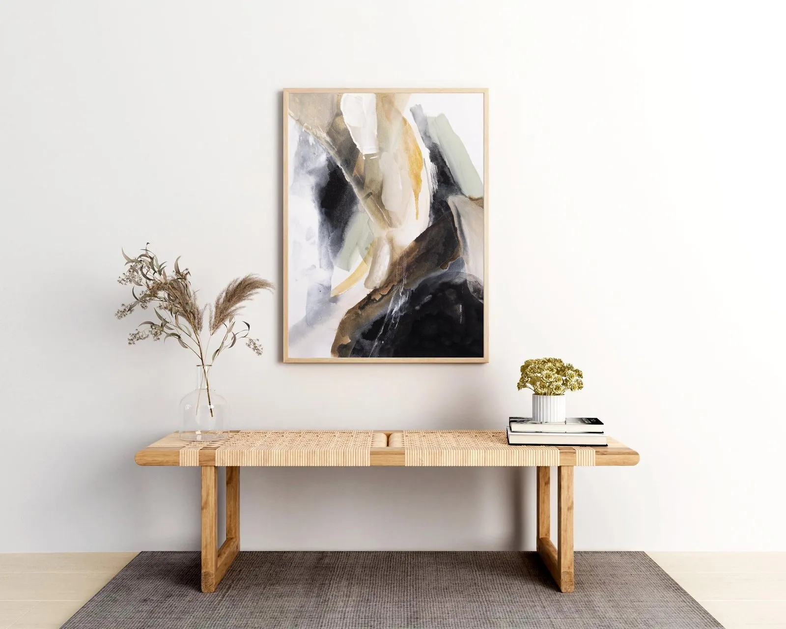 Neutral abstract painting above a wooden bench with dried grasses