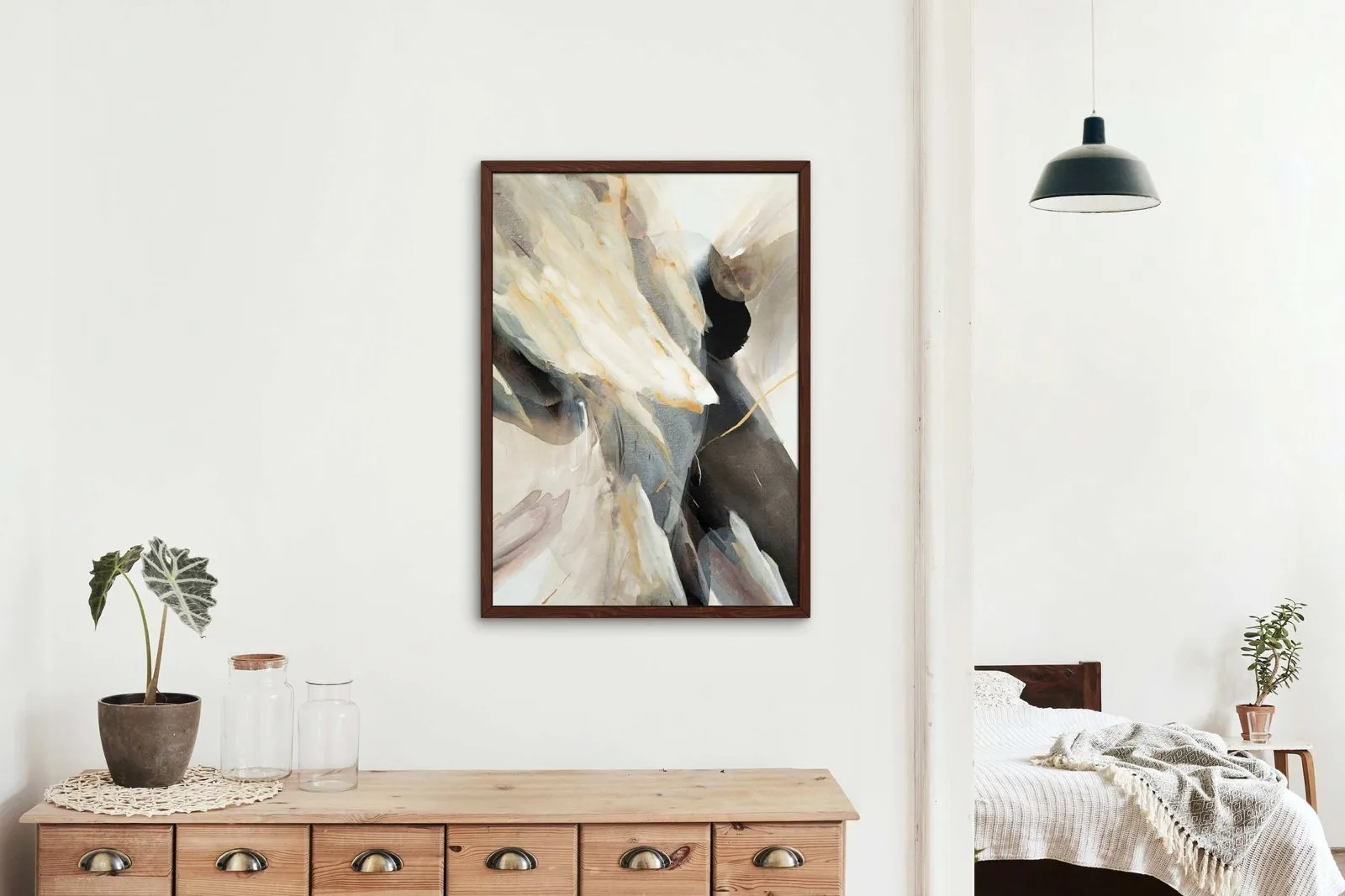 Abstract painting above a wooden dresser next to a bedroom